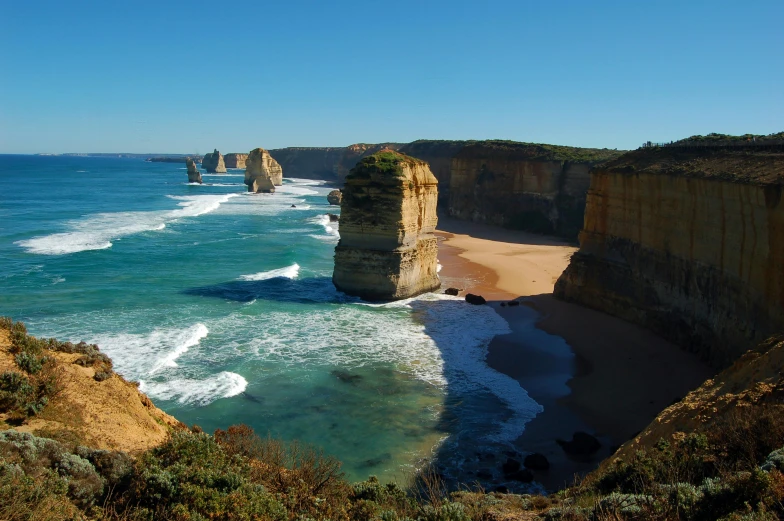 a large body of water sitting on top of a sandy beach, pexels contest winner, baroque, coastal cliffs, avatar image, aussie, chiseled formations