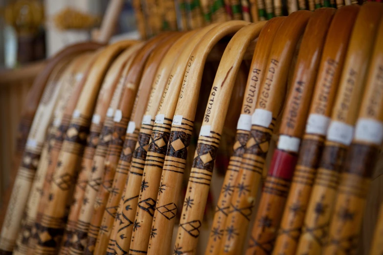 a row of wooden baseball bats sitting next to each other, a picture, hurufiyya, embroidered robes, inside an arabian market bazaar, arrows, shot on sony alpha dslr-a300