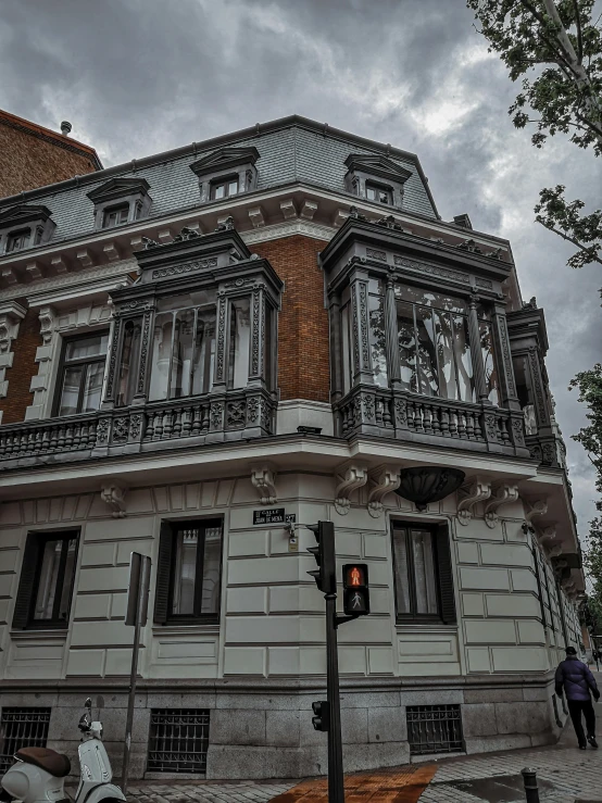 a couple of scooters parked in front of a building, a photo, by Alejandro Obregón, pexels contest winner, art nouveau, gothic mansion, window ( city ), buenos aires, looking around a corner