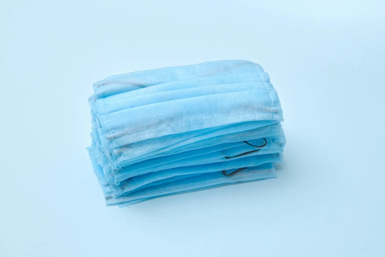 a stack of blue surgical face masks on a white surface, happening, product image, light blue mist, mid-30s, thumbnail