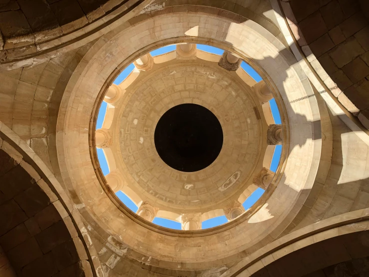 the ceiling of a building with a blue sky in the center, an album cover, by Jan Rustem, trending on unsplash, baroque, circular towers, inside a tomb, monserrat gudiol, ventilation shafts