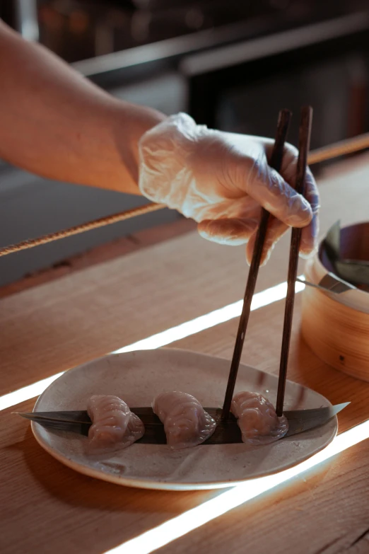 a person holding chopsticks over a plate of food, gloves on hands, momoshiki ōtsutsuki, rays, sydney hanson