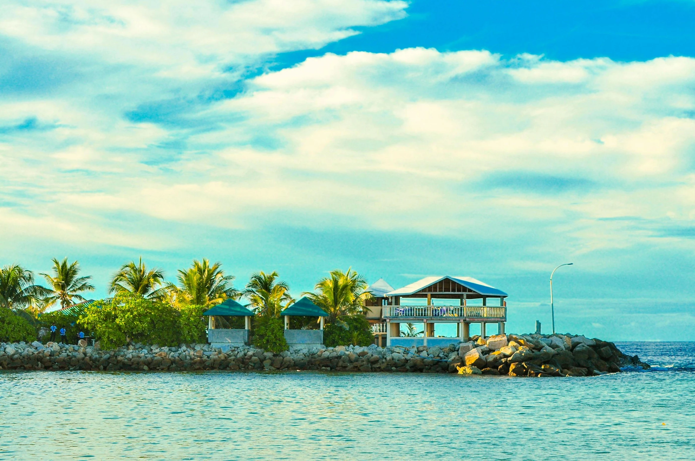 a small island in the middle of the ocean, by Nicholas Marsicano, unsplash, kicking a florida mansion, beach bar, profile image, teal sky