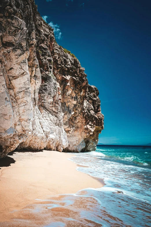 a sandy beach with a cliff in the background, pexels contest winner, baroque, caribbean, studio shot, byzantine, multiple stories