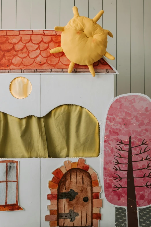 a cardboard doll house sitting on top of a table, a child's drawing, inspired by Elsa Beskow, trending on unsplash, folk art, sun rising, fuzzy orange puppet, detail shot, fabrics