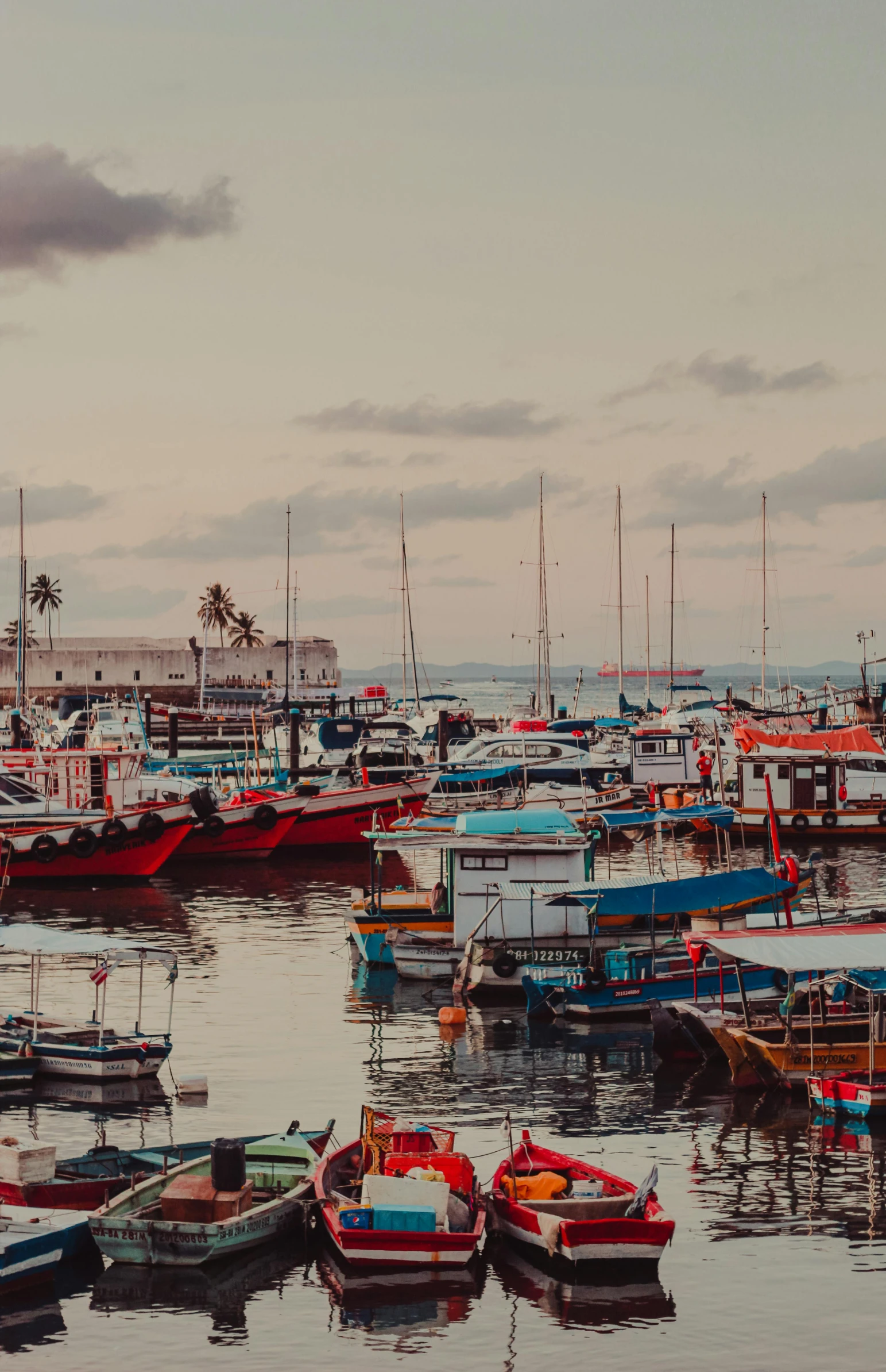 a number of boats in a body of water, a colorized photo, pexels contest winner, streets of salvador, near a jetty, background image, high resolution photo