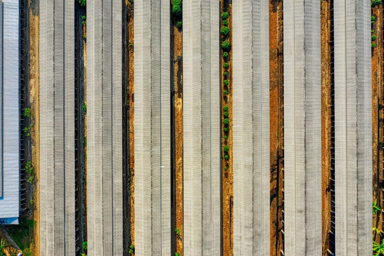 a fire hydrant sitting next to a wooden fence, inspired by Andreas Gursky, aerial shot from the drone, concrete pillars, reza afshar, railways