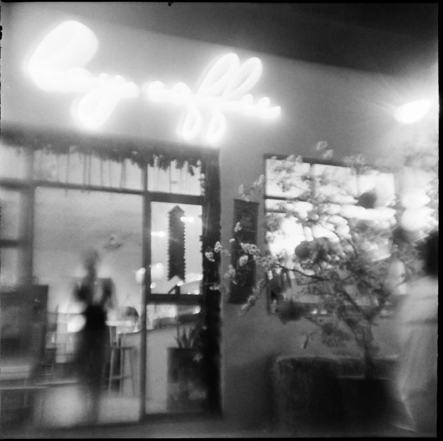 a black and white photo of a coffee shop, inspired by Louis Faurer, holga 120n, keng lye, (tropicalism), ivy's