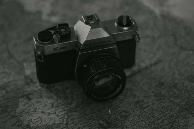 a black and white photo of a camera on a map, pexels contest winner, 8 0 s camera, pentax k 1 0 0 0, complex and desaturated, posing for a picture