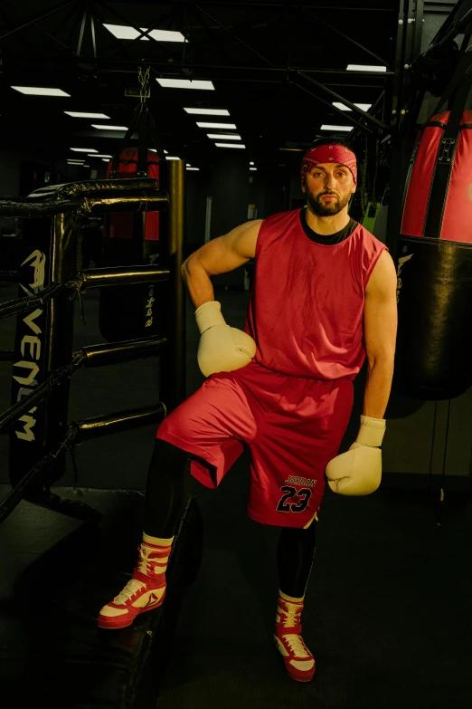 a man sitting on a punching bag in a gym, a portrait, featured on reddit, lycra costume, red sport clothing, covered in pink flesh, rugged man portrait