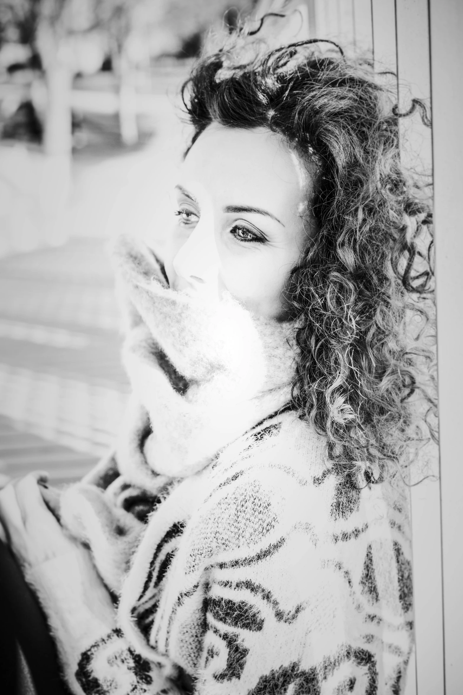 a black and white photo of a woman with curly hair, a black and white photo, inspired by Anita Malfatti, * colour splash *, cuddly fur, chilly, low quality photograph