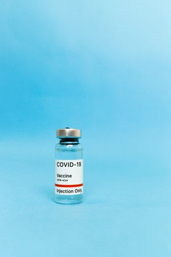 a vial of e - cov vaccine on a blue background, a picture, by Gavin Hamilton, shutterstock, instagram picture, 1 9 th, profile pic, grey