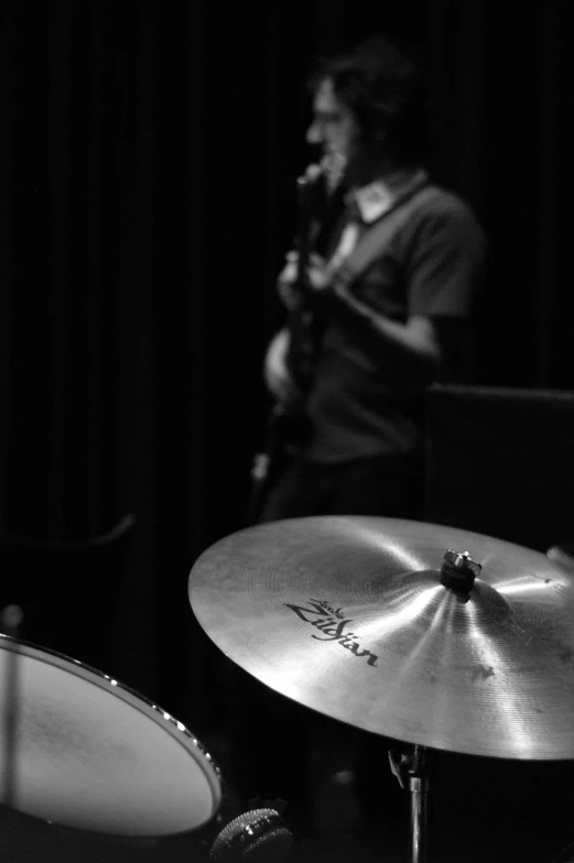 a black and white photo of a man playing the drums, flickr, detailed an empty jazz cafe, bassist, medium closeup, featured