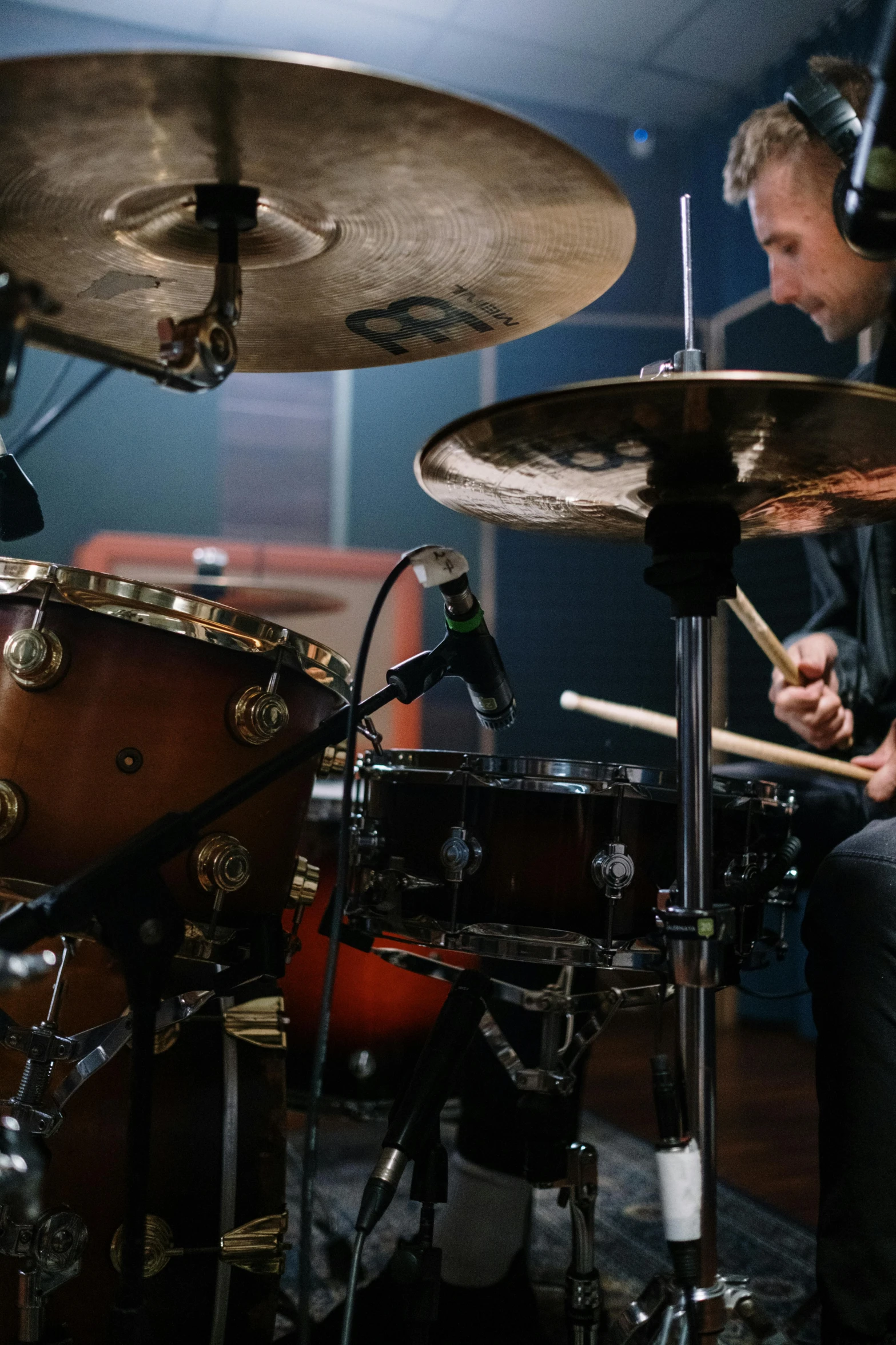 a man sitting in front of a drum set