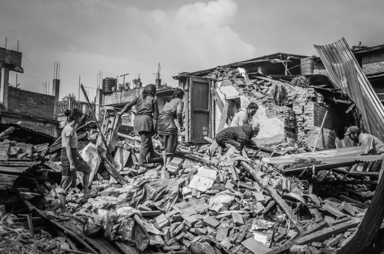 a group of men standing next to a pile of rubble, a black and white photo, by Judith Gutierrez, pexels contest winner, auto-destructive art, jakarta, destroying houses, an intricate, dressed in a worn