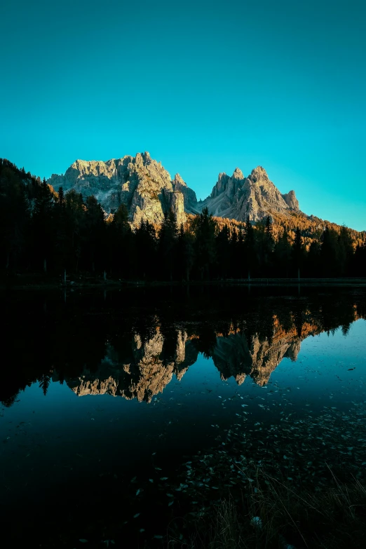 the mountains are reflected in the water, a picture, by Sebastian Spreng, romanticism, lago di sorapis, majestic spires, low-light, panoramic photography