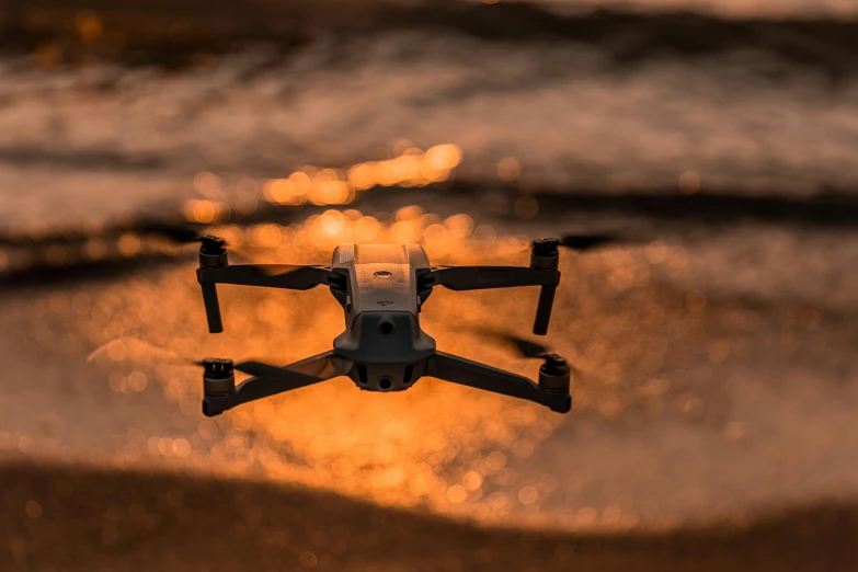 a small drone flying over a body of water, pexels contest winner, hurufiyya, thumbnail, sunset lighting 8k, electronics, shallow depth