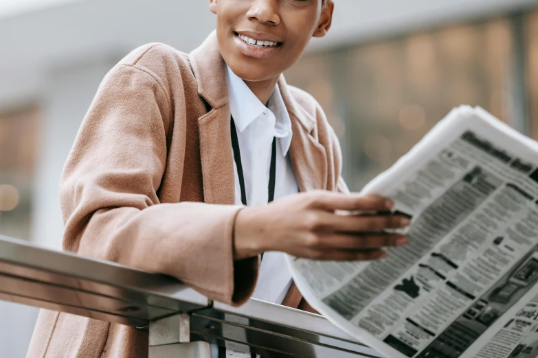 a close up of a person holding a newspaper, a confident smile, profile image, androgynous person, professional image