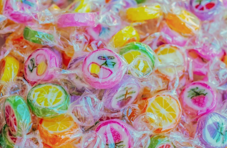 a pile of colorful lollipops sitting on top of each other, by Emma Andijewska, pexels, plastic wrap, pink and yellow, fruit, 15081959 21121991 01012000 4k