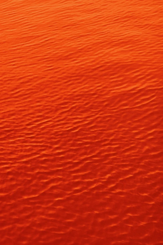 a boat floating on top of a body of water, an album cover, inspired by Christo, pexels contest winner, symbolism, red caviar instead of sand, orange subsurface scattering, texture of sand, red glow