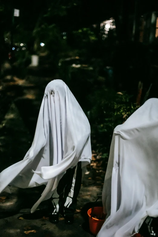 a couple of chairs covered in white cloth, trending on unsplash, happening, hair made of shimmering ghosts, walking towards camera, pointed hoods, diverse costumes