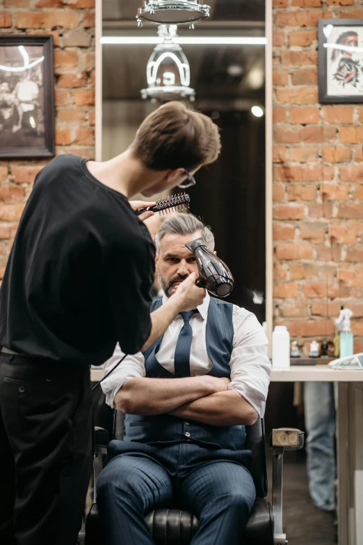 a man getting his hair cut at a barber shop, pexels contest winner, at a fashion shoot, long neck, 🎨🖌, serious business