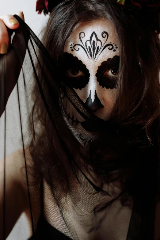 a woman wearing a mask with flowers in her hair, pexels contest winner, gothic art, markings on her face, low quality photo, trick or treat, she is mexican