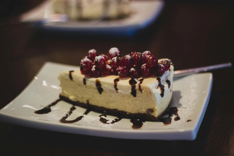 a piece of cake sitting on top of a white plate, unsplash, server, decorated, daily specials, brown