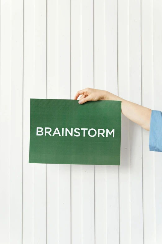 a woman holding a sign that says brainstorm, inspired by Wilhelm Hammershøi, dark green, frontal shot, thunderstom, cardstock