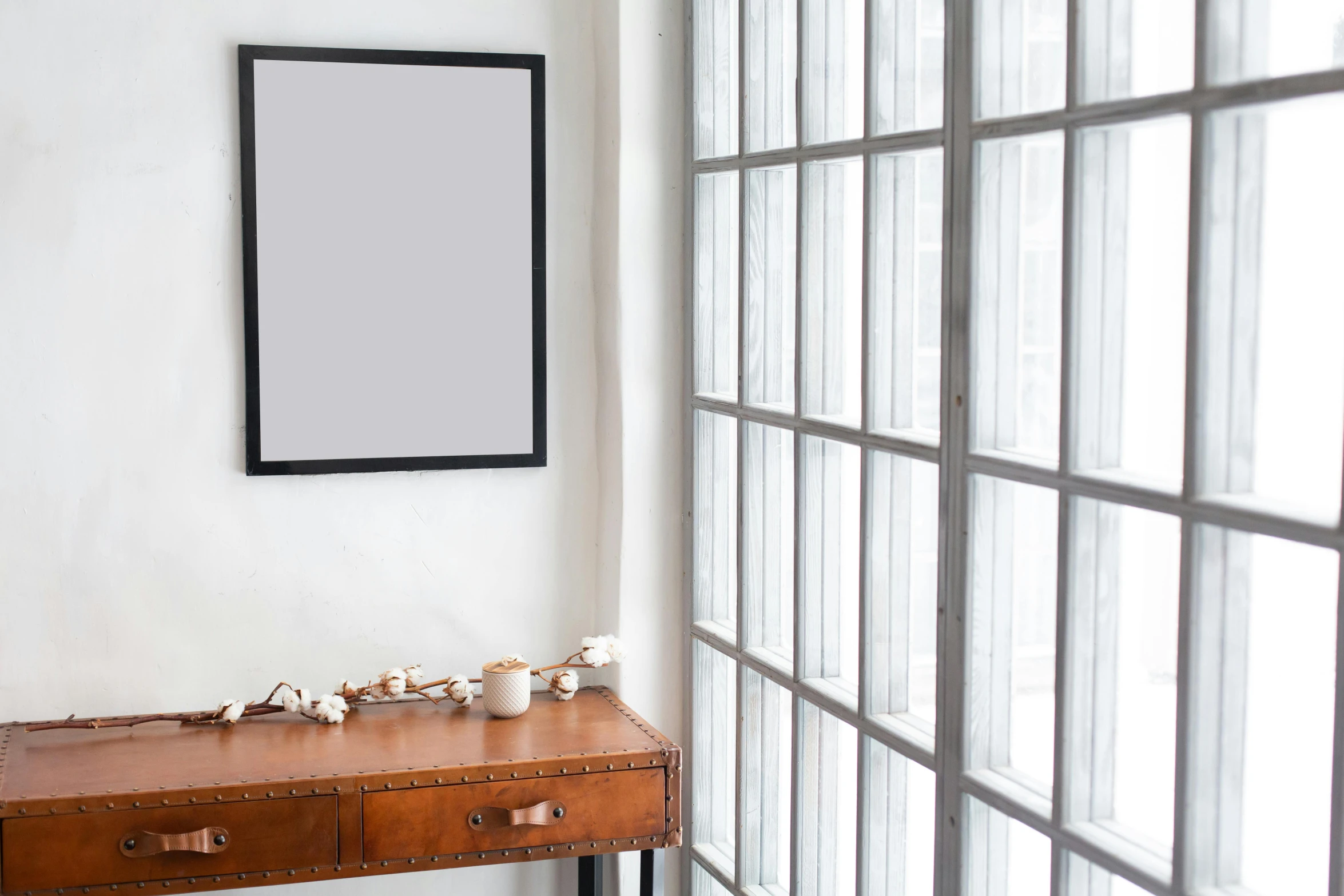 a picture frame sitting on top of a wooden table, a poster, inspired by Agnes Martin, trending on unsplash, iron frame, digital pong screen, background image