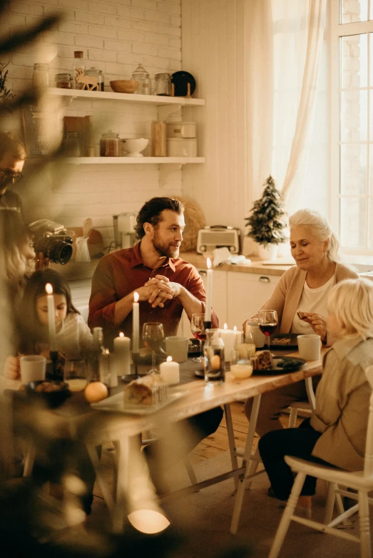 a group of people sitting around a table, holiday season, home display, profile image, golden light