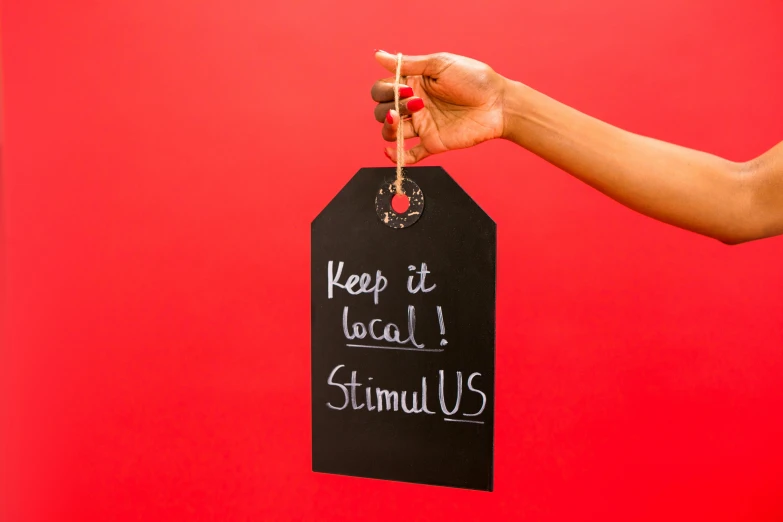 a person holding a sign that says keep it local, stuckism, on a red background, blackboard, kikis delivery service, thumbnail