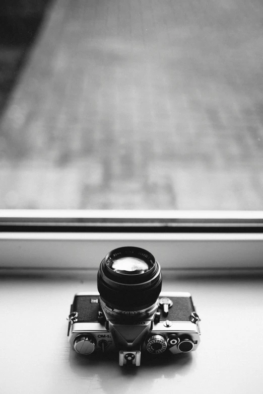 a camera sitting on top of a window sill, inspired by Vivian Maier, minimalism, epic. 1 0 0 mm, looking at camera!!!, cameras lenses, on a mini world