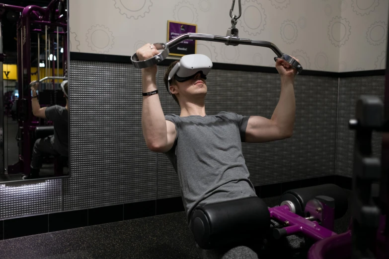 a man using a vr headset in a gym, by Meredith Dillman, in a planet fitness, purple tubes, pulling the move'derp banshee ', lachlan bailey