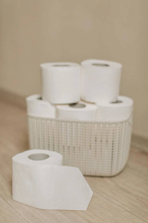 a pile of toilet paper sitting on top of a wooden floor