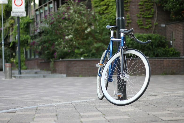 a bicycle parked on the side of a street, white and blue, profile image, b - roll, symmetrical rim light