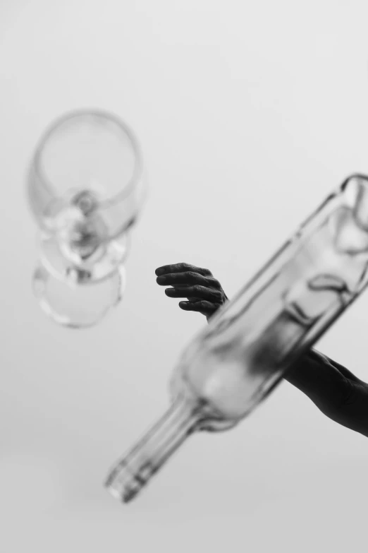 a black and white photo of a woman holding a bottle, by Adam Marczyński, unsplash, conceptual art, blown glass figure, surgical iv drip, miniature photography closeup, levers