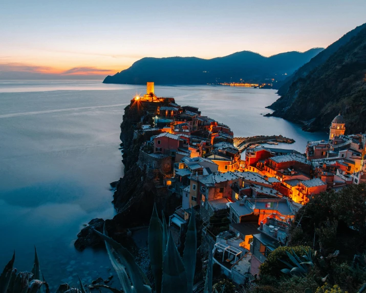 a town sitting on top of a cliff next to the ocean, pexels contest winner, renaissance, at dusk lighting, vouge italy, quaint village, breathtaking lights