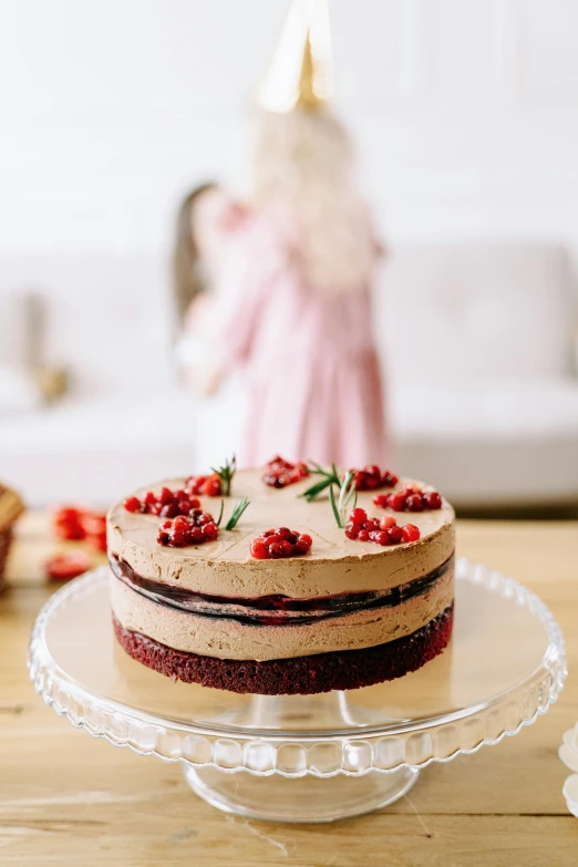 a cake sitting on top of a glass cake plate, by Julia Pishtar, pexels contest winner, dressed in velvet, panoramic view of girl, high quality product image”, petite