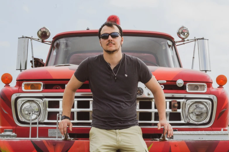 a man standing in front of a red truck, an album cover, pexels contest winner, headshot profile picture, mike stoklasa, discord profile picture, smokey