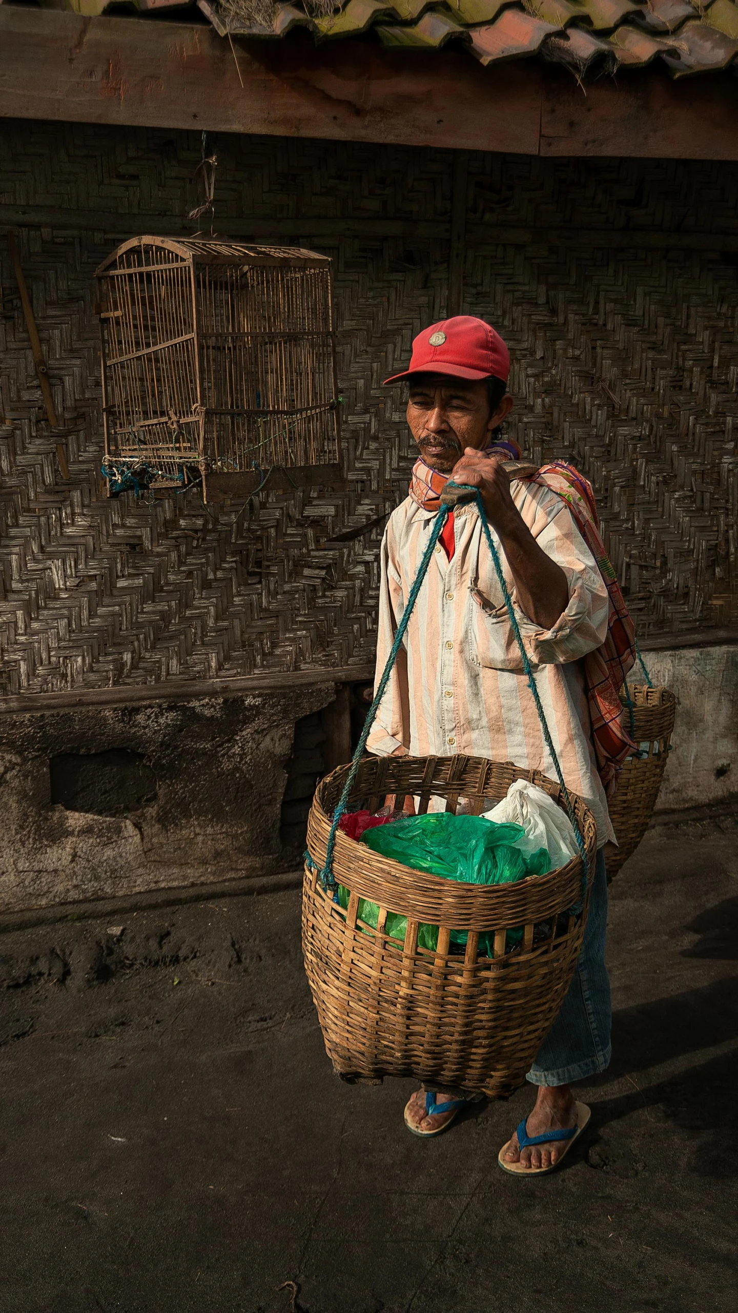 a woman walking down a street with a basket on her shoulder, by Jan Tengnagel, pexels contest winner, bangladesh, man standing, 15081959 21121991 01012000 4k