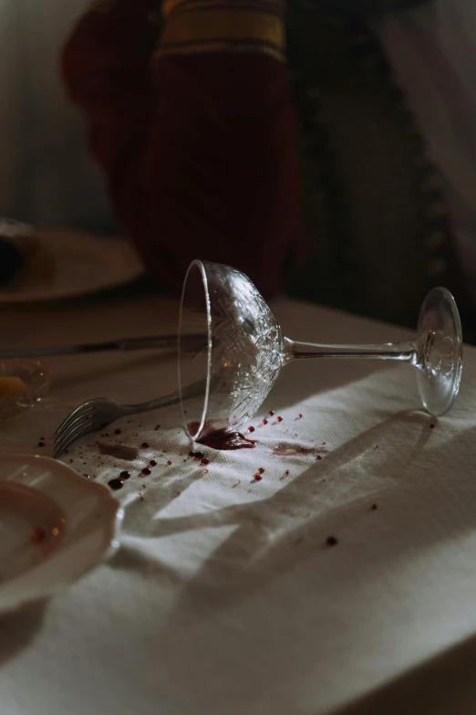 a dirty wine glass sitting on top of a table, by Elsa Bleda, renaissance, award winning movie still, crashed, ignant, fine dining