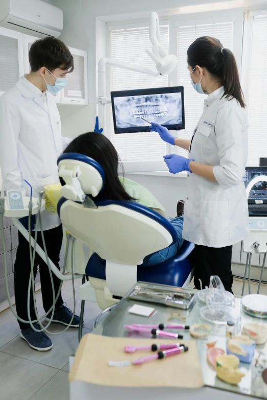 a couple of people that are sitting in a chair, dentist, large screen, lim chuan shin, soft volume absorbation