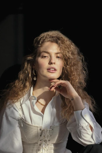 a woman in a white dress posing for a picture, an album cover, inspired by Elsa Bleda, trending on pexels, renaissance, ginger wavy hair, androgynous person, actress, silver curly hair
