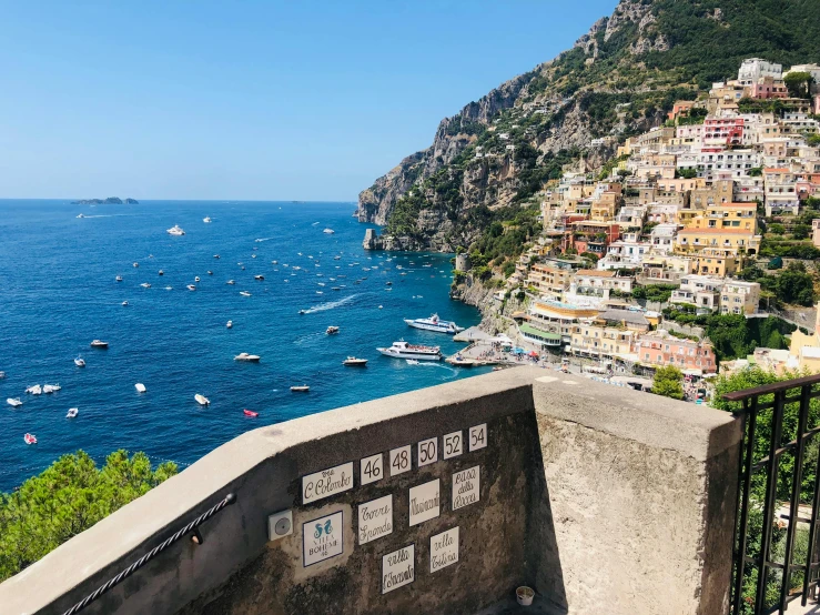 a balcony with a view of boats in the water, a photo, pexels contest winner, renaissance, cliffside town, on a sunny day, tiles, trulli