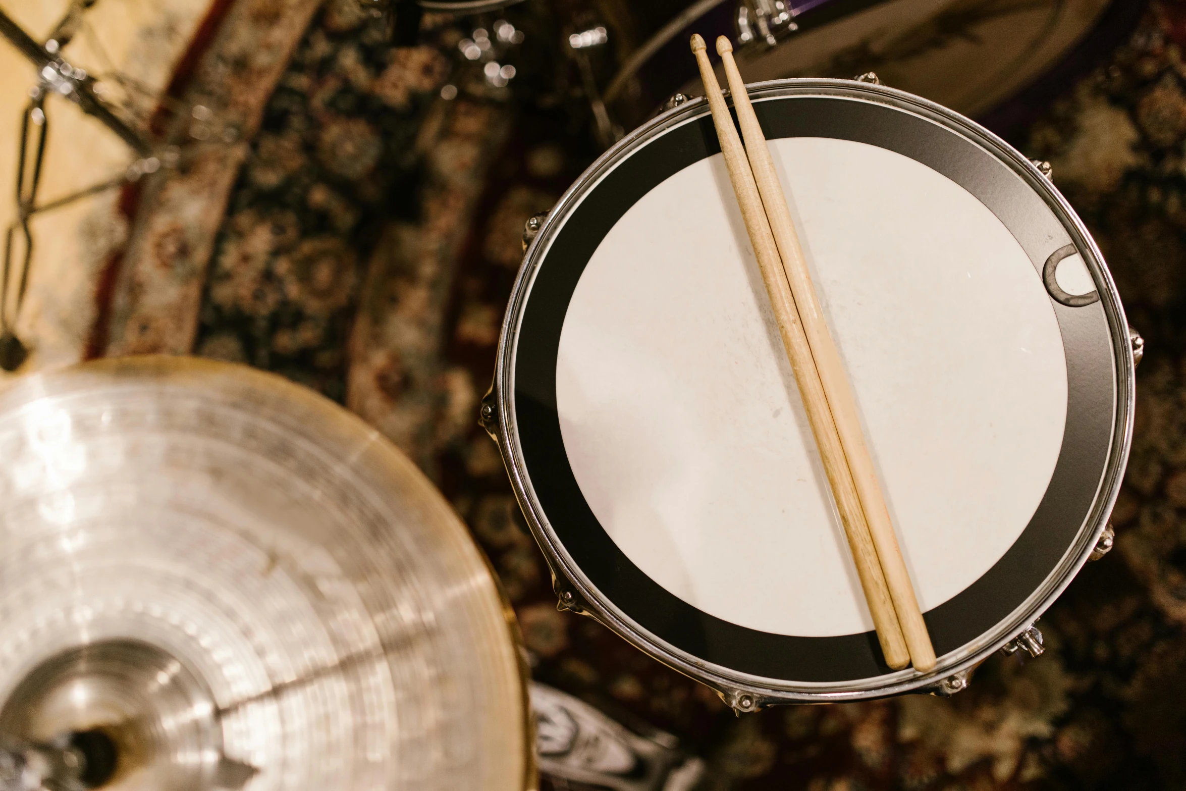 a drum set up with drums and drumsticks, by Drew Tucker, trending on unsplash, high angle close up shot, plush leather pads, white, 1 2 9 7