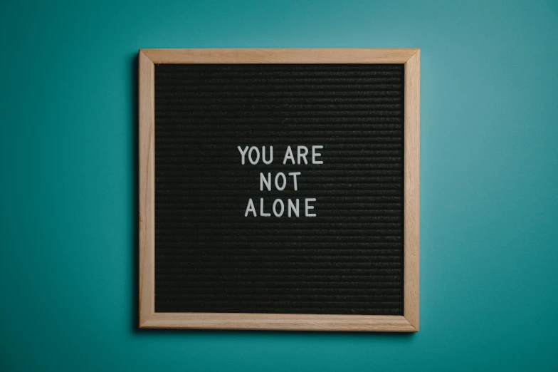 a letter board that says you are not alone, a poster, pexels, sots art, square, depression, flat, panel of black