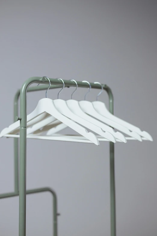 a rack that has a bunch of hangers on it, unsplash, process art, soft white rubber, marvelous designer substance, close-up product photo, smooth matte