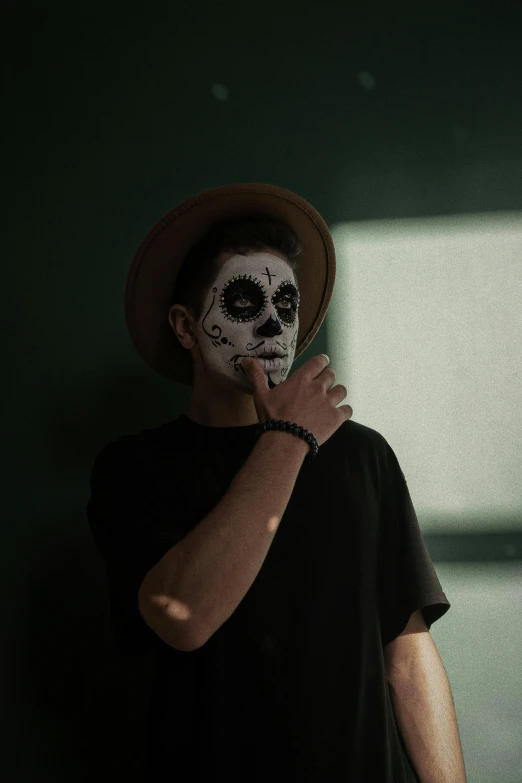 a man with a skeleton face painted on his face, pexels contest winner, dark hat, teen boy, mexican, ad image