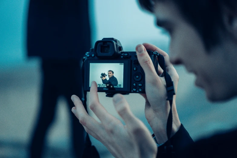 a person taking a picture with a camera, by Adam Marczyński, visual art, **cinematic, full - frame, looking into a mirror, medium format